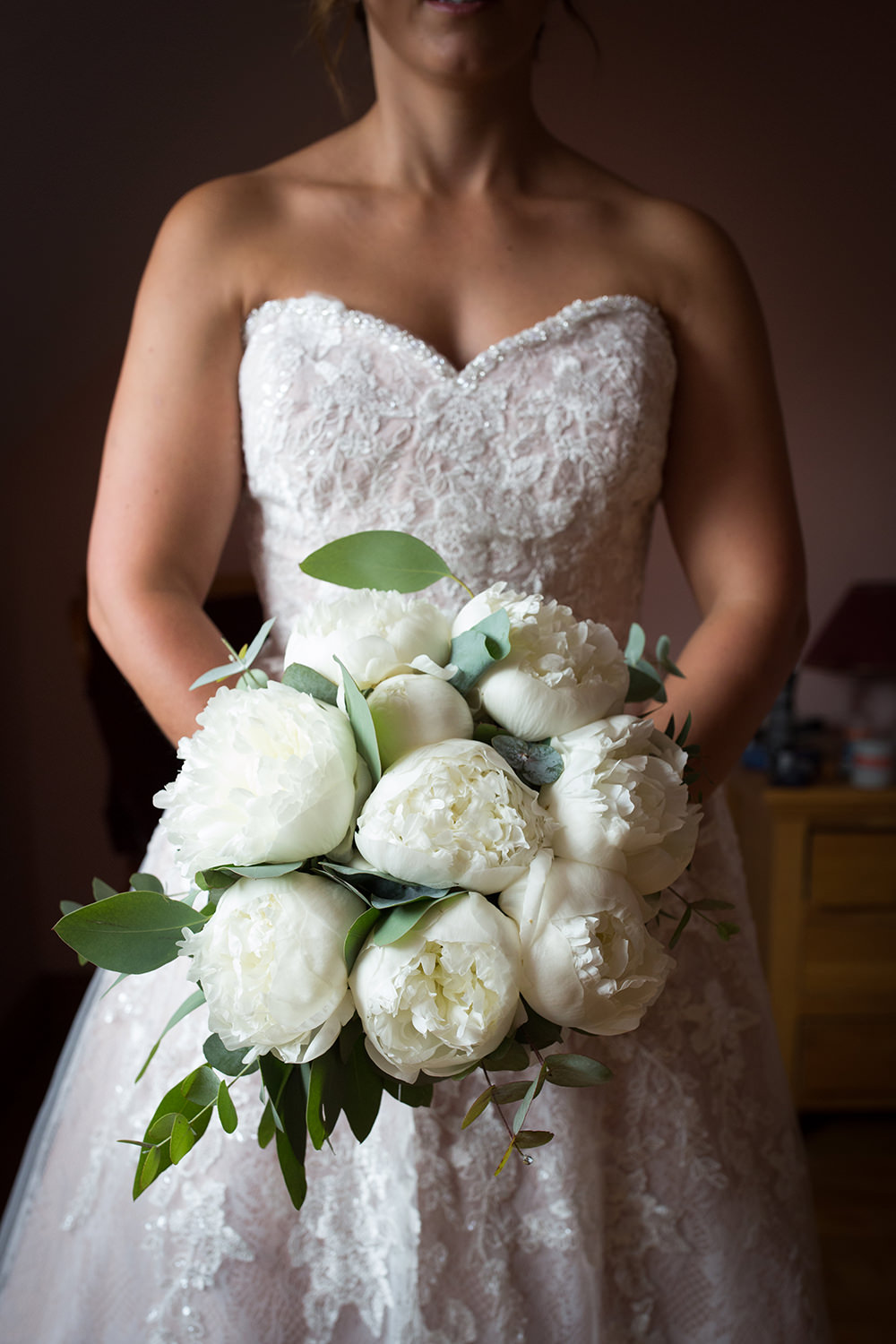 white peonie roses in wedding bouquet