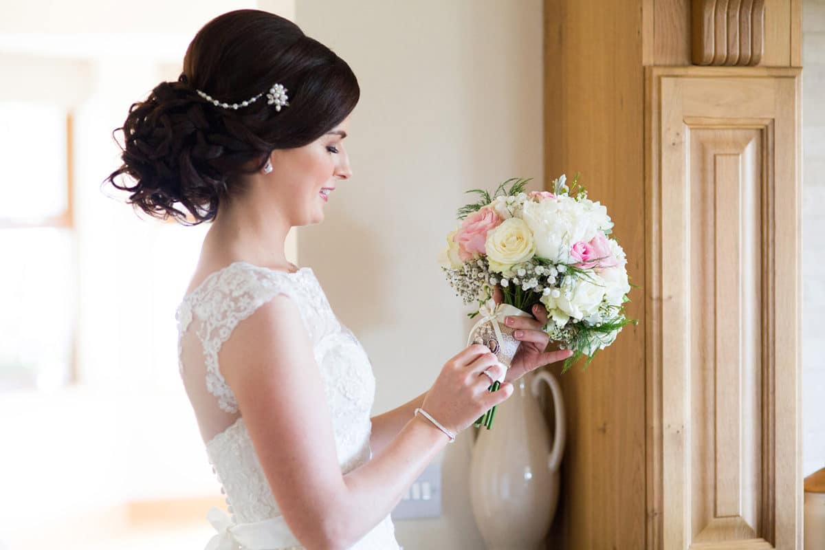 bride looking at flower bouquet