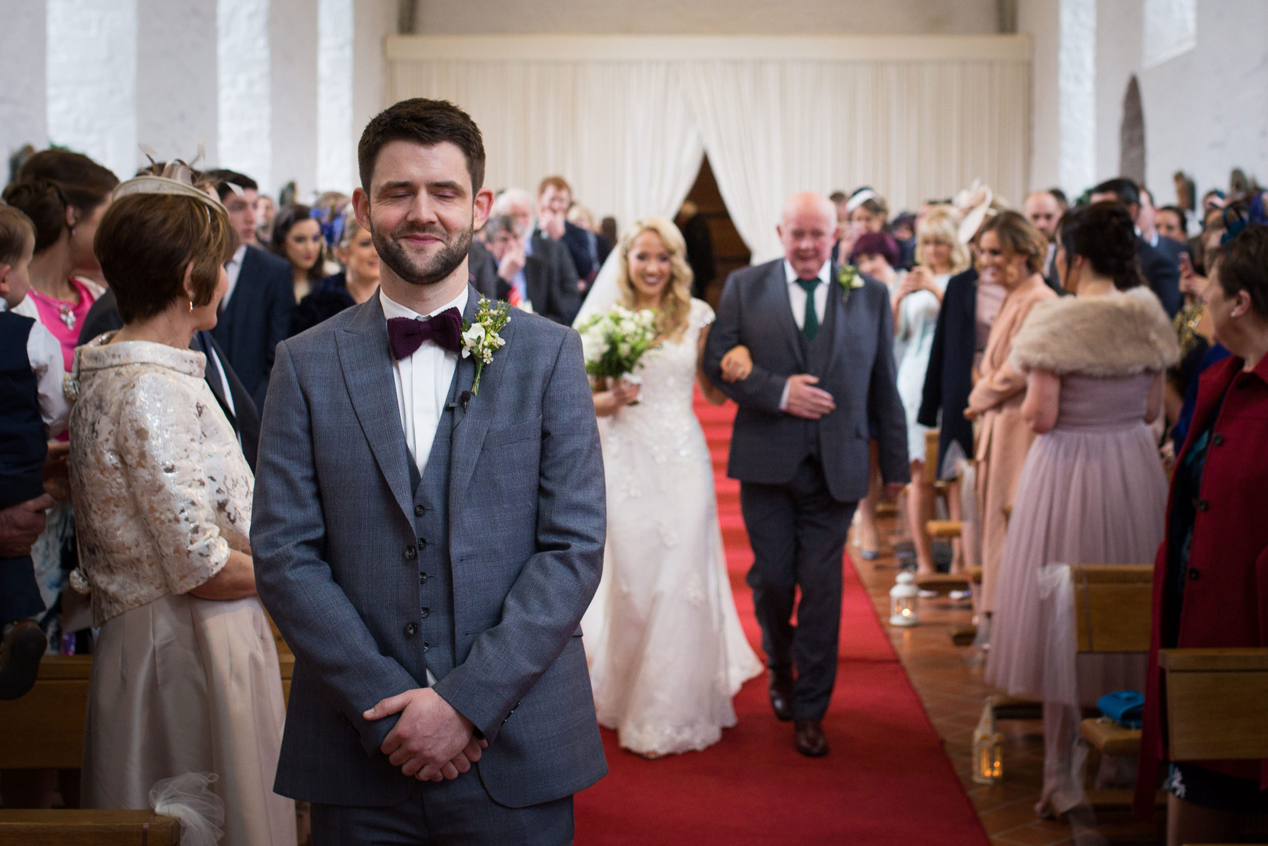 groom waits for bride at top of aisle in ballintubber abbey and knockranny westport